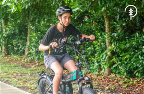 Boy riding e-bike at park