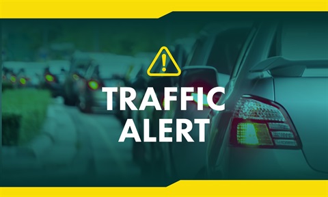 A green faded background showing cars in traffic-copy that reads TRAFFIC ALERT