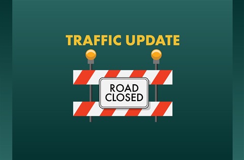 Image of green background with text that reads: TRAFFIC UPDATE; image of a barricade shows below that and this text: ROAD CLOSED