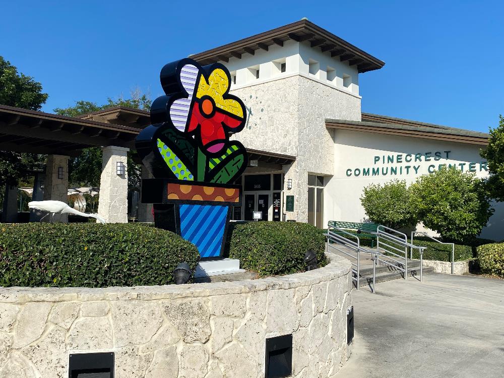 Community Center building with colorful flower sculpture in front