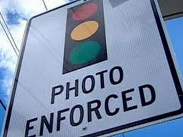 Sign with Traffic light photo enforced